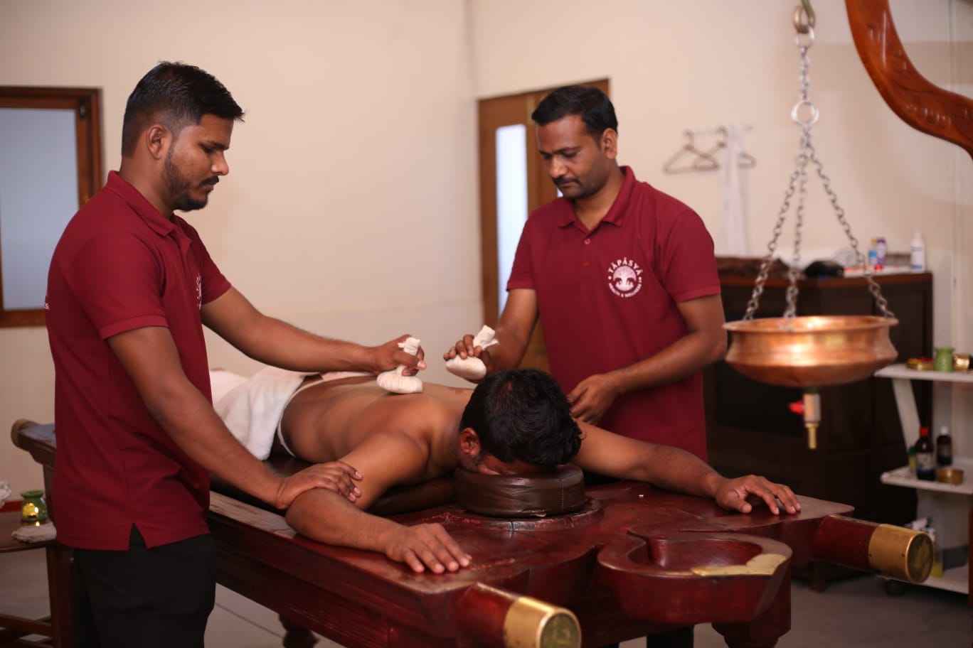 Two-therapist potli massage, wide view, at Tapasya Health & Wellness